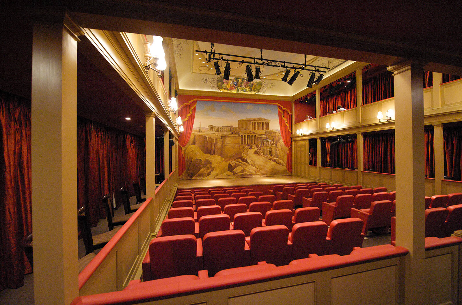 Theatre with red seats and red side curtains